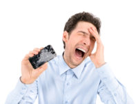 Angry man showing broken smartphone