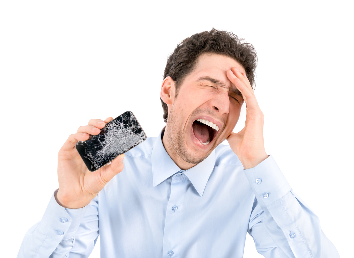 Angry man showing broken smartphone