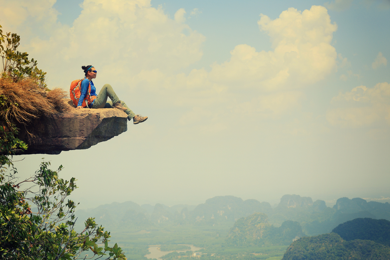 young asian woman enjoy the view at mountain peak