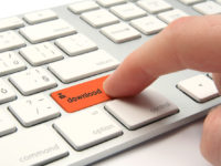 Finger pressing orange download button on a white keyboard