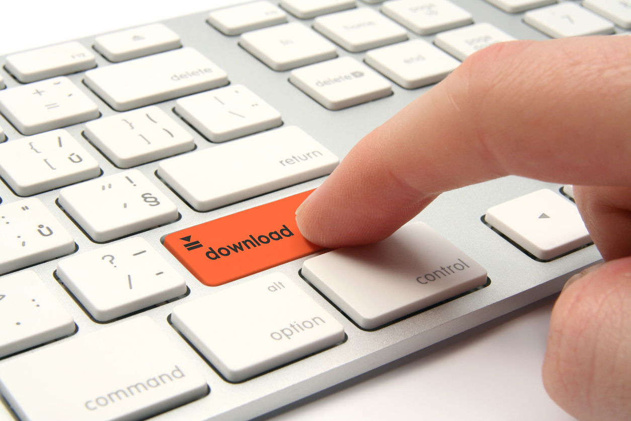 Finger pressing orange download button on a white keyboard