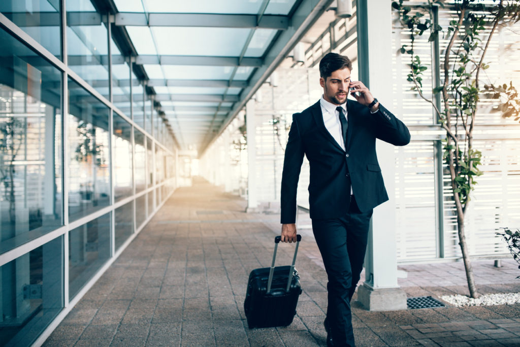 Travelling businessman making phone call