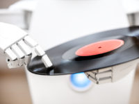 music robot is playing a record while touching with his finger the record. Cocept music streaming or downloading, futuristic music player