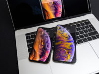 Apple iPhone Xs Max Gold Silver Smartphone on laptop