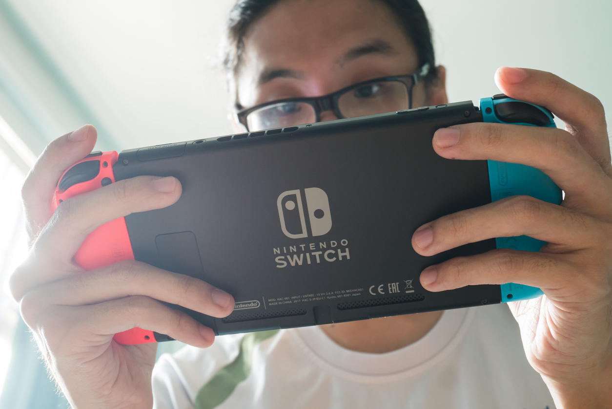 A man playing Nintendo Switch.