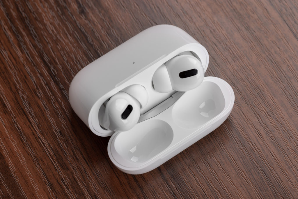 Apple AirPods Pro on a wooden table.