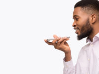 Black man using voice assistant on mobile phone
