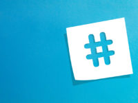 Hashtag sign on white information paper
