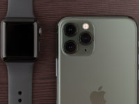Apple iPhone 11 Pro Midnight Green on a wooden surface.